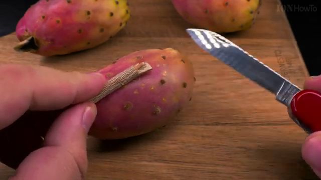 Cutting both ends off cactus fruit with a sharp knife
